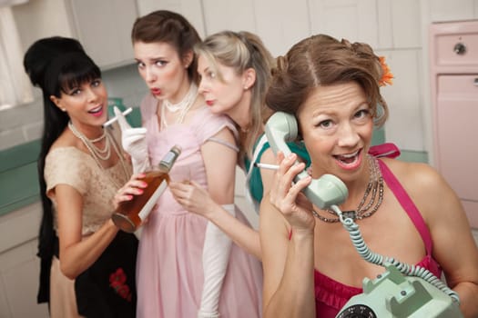 Group of four retro fashion housewives tell secrets in the kitchen