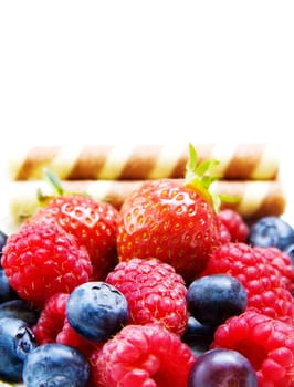 Fruits Delight - raspberry, strawberry, blueberry and waffles isolated on white background.