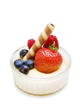 Delicious dessert - creme brulee with strawberry, raspberry, blueberry and chocolate waffle isolated on white.