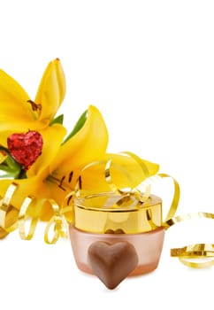Perfect gift for the celebration of a special day - luxury face cream with flower, golden ribbons and heart chocolates. Isolated over white background.
