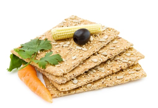 Healthy snacks - organic cheese crackers with olives, carrots and baby corn. Isolated on white background.