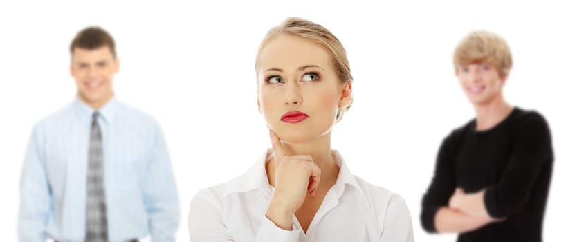 Thoughtful business woman looking right (making a choice) , isolated over a white background. Two young man in background