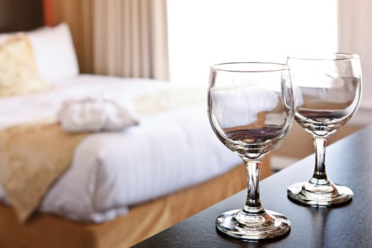 Romantic bedroom with wine glasses in luxury hotel interior
