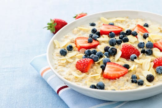 Bowl of hot oatmeal breakfast cereal with fresh berries
