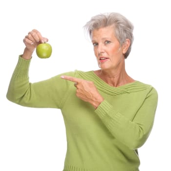 Studio shot of an active senior woman with an apple