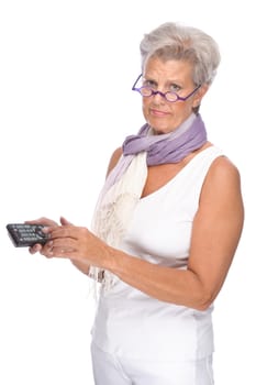 Studio shot of an active senior woman with remote control