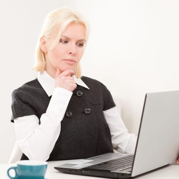 Young businesswoman sitting at desk with computer
