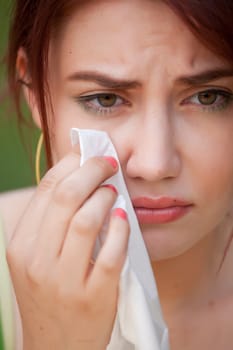 portrait of young crying woman with handkerchief