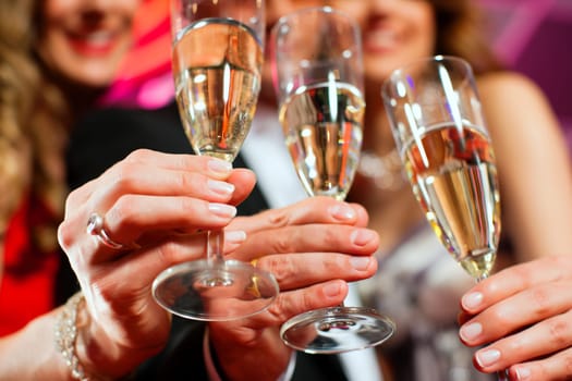 People with champagne in a bar