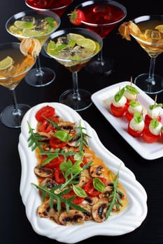 Appetizers with drinks for guests with champignon carpaccio