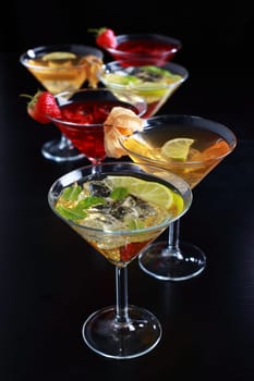 Different cocktails or longdrinks garnished with fruits