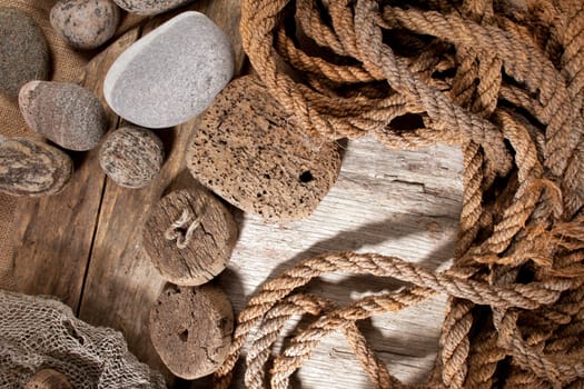 Cork, rope and stones on wooden background