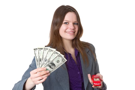 Attractive woman with banknotes and model car isolated on white background