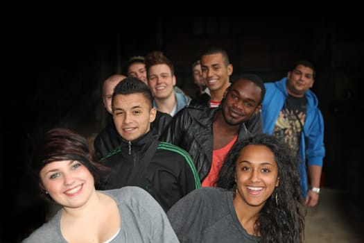 Cheerful group of young students of different nationalities in a row