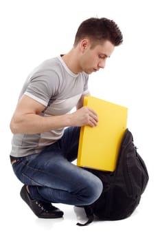 Young student packing his big yellow file
