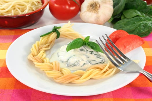 a plaited pasta with spinach cheese sauce with fresh ingredients