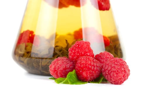 Teapot with fruit tea and berries on a white background