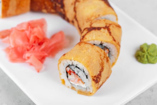 Sushi - made of crab meat, cheese, omelette outside