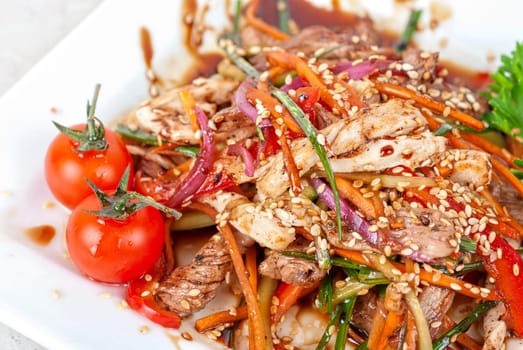 Tasty appetizer of roast beef meat, marinated chicken meat, cherry tomato and other vegetables