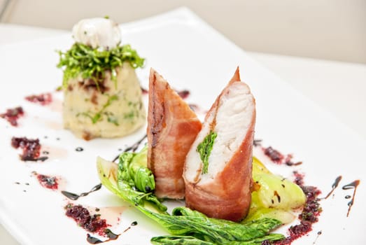 Tasty dish of pike perch at bacon with basilica, lettuce, dill, parsley, pepper and quail egg