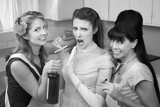 Young woman goes along with friends to smoke and drink in a kitchen