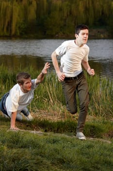 A young man fell in running next to his friend