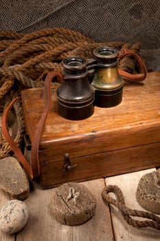 Antique binoculars on old wooden box