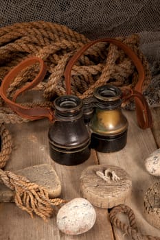 Antique binoculars on old wood