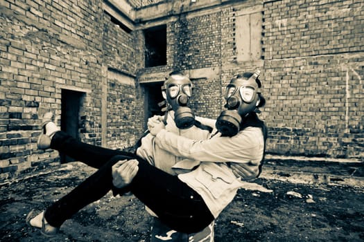 Bizarre portrait of romantic couple with gas masks