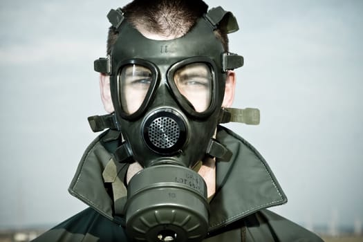 Bizarre portrait of man in gas mask