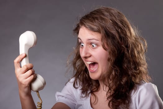 Mad woman shouting at old phone