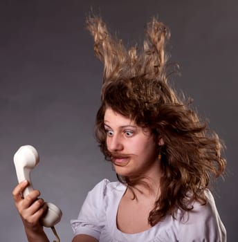 Mad woman shouting at old phone