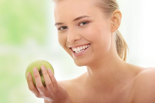 Beautiful girl eating green apple