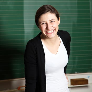 Laughing woman in front of blackboard - Copy space - Square