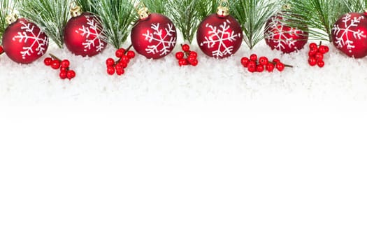 Christmas border with red ornaments and pine branches