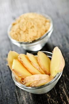 Sliced and ground fresh ginger root spice in glass bowls