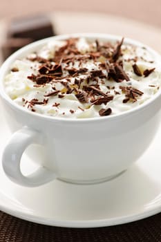 Cup of hot cocoa with shaved chocolate and whipped cream