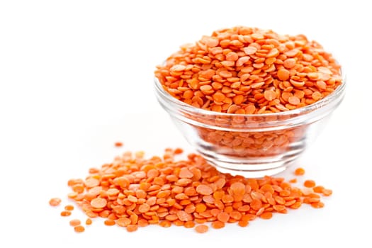 Bowl of red lentils isolated on white background
