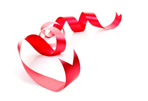Curled red holiday ribbon strip isolated on white background