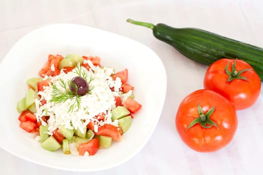 Fresh Mediterranean salad with tomatoes, cucumber, onion, feta cheese and olive.