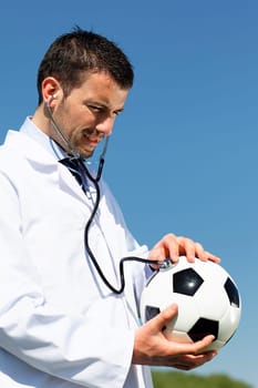 doctor with ball and stethoscope in blue sky