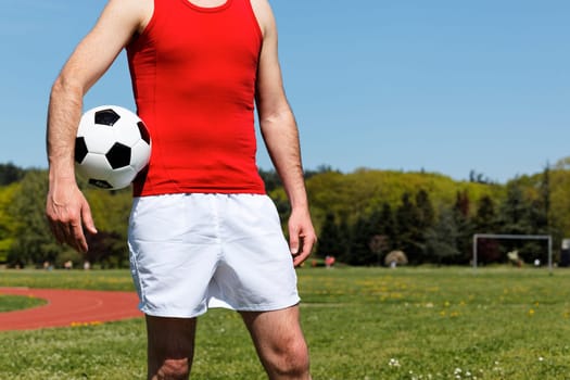 man with a ball in park in summer