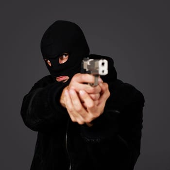black dressed man with gun in studio