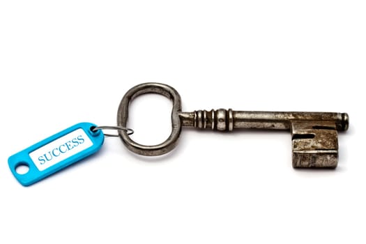 Key with a success tag closeup on white background