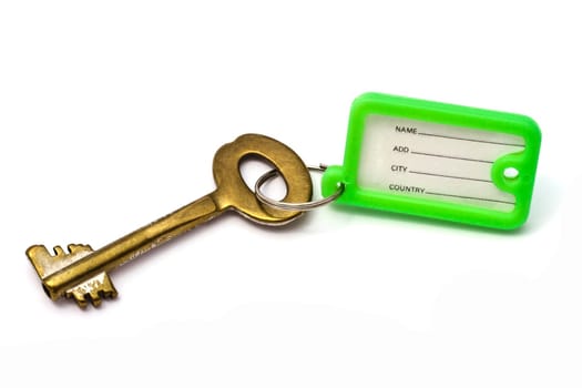 Old key with tag closeup on white background
