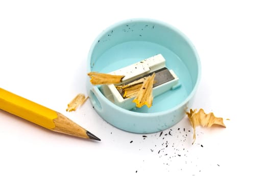 Pencil and sharpener closeup on white background