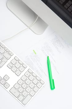 Programmer workplace - printed code with highlighter and computer