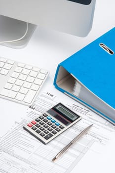 Tax concept - tax form, part of computer, keyboard, calculator, office folder and pen
