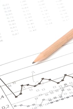 Business report, pencil, graph and sheet and calculator. Selective focus on arrow.