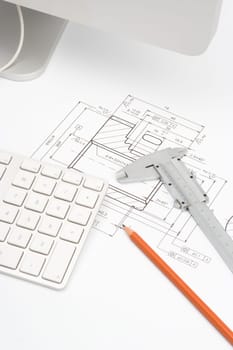 Mechanical engineer workplace - blueprint of gearwheel, caliper, pencil and part of computer